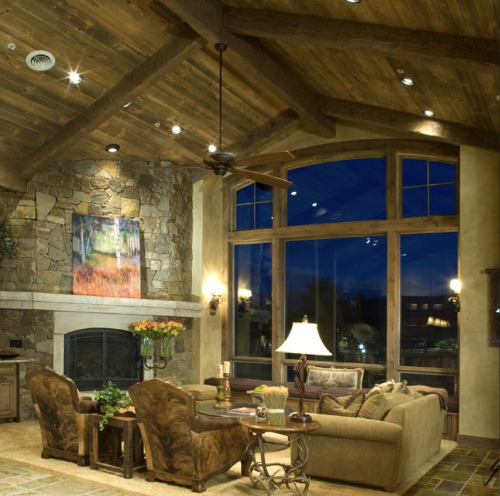 Vaulted ceiling with brick walls and large bay windows.